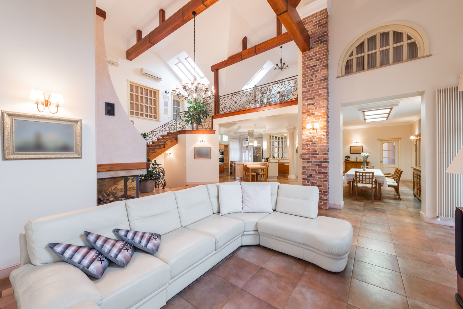 Living room with couch near kitchen and stairway